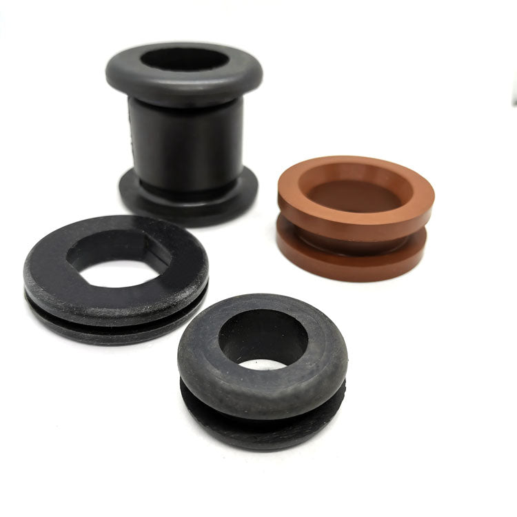Black and brown molded rubber grommets with center openings and varied double-flanged profiles