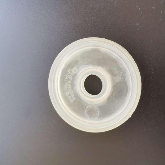 Translucent pump membrane marked 1150130 on a dark work surface