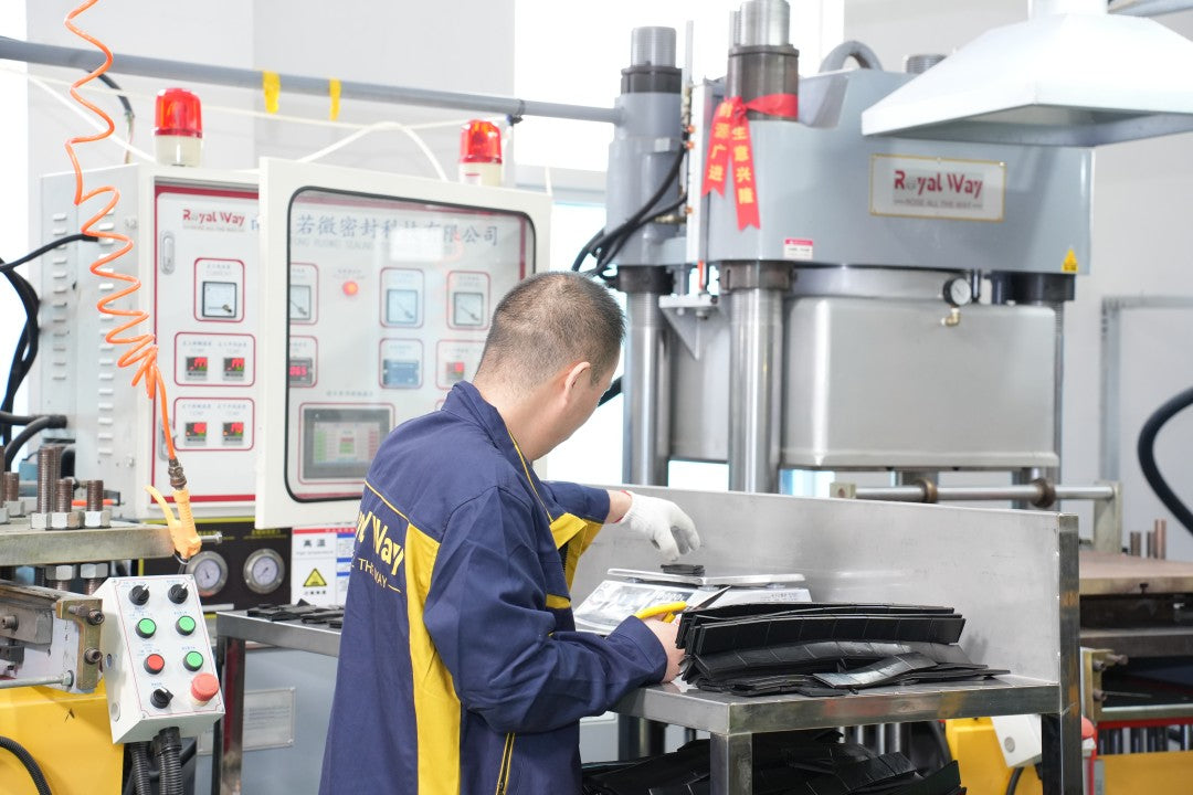 Royal Way operator working beside rubber molding presses