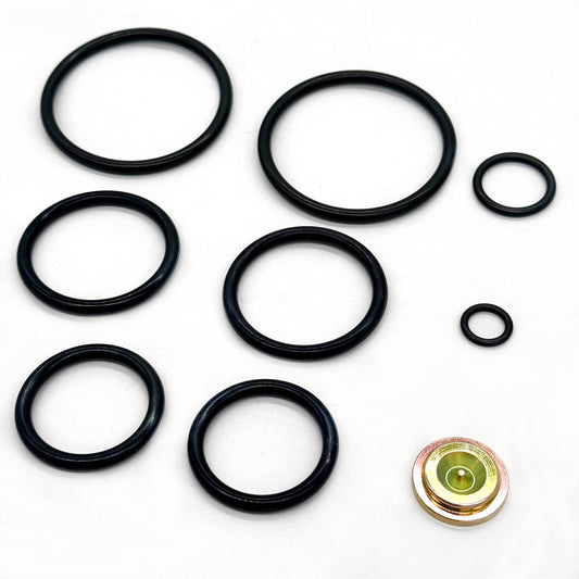Baker Style #20 short-stroke redress kit sealing rings and metal component on a white background