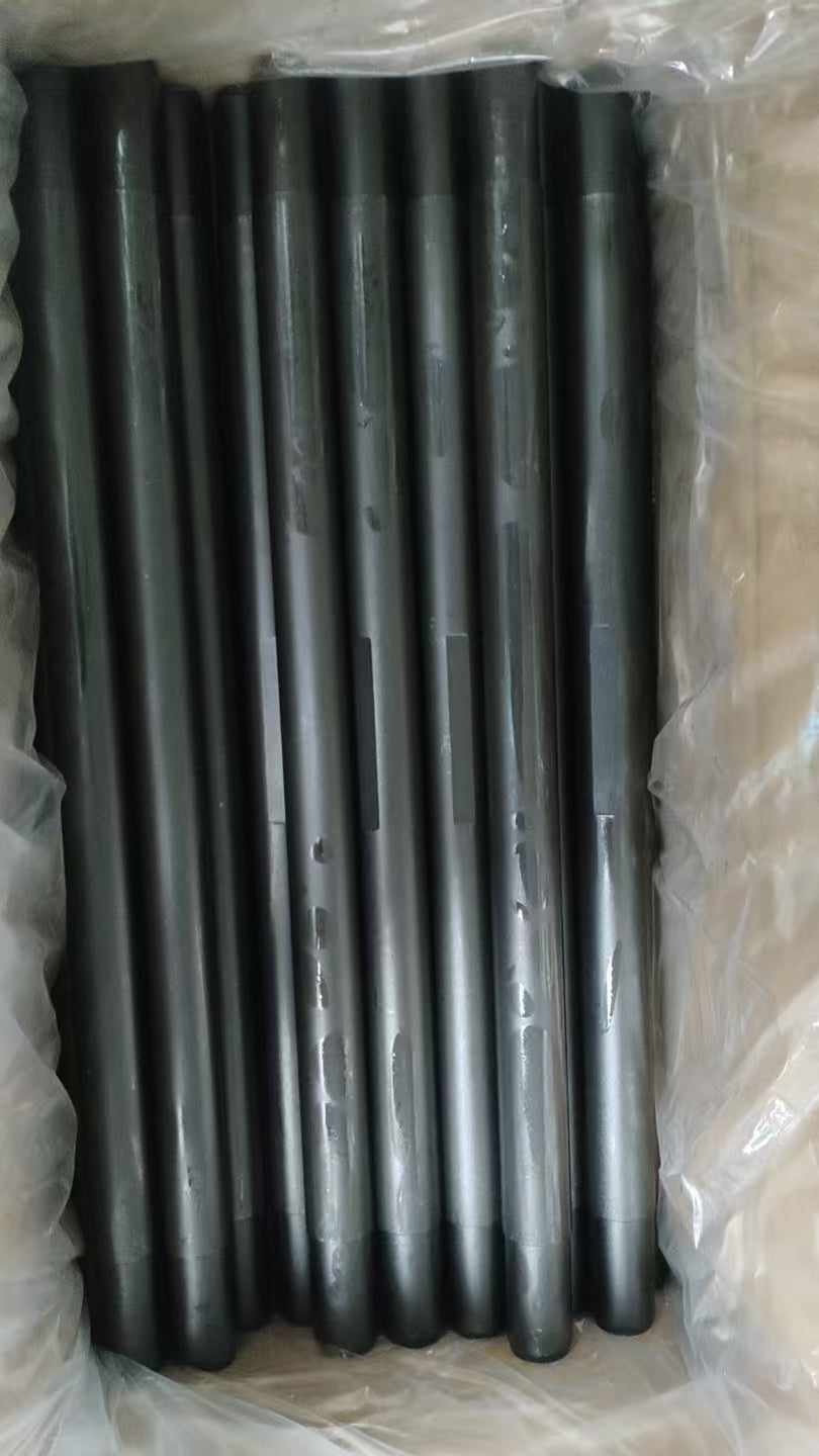 Black coated wireline flow tubes arranged in protective packaging.