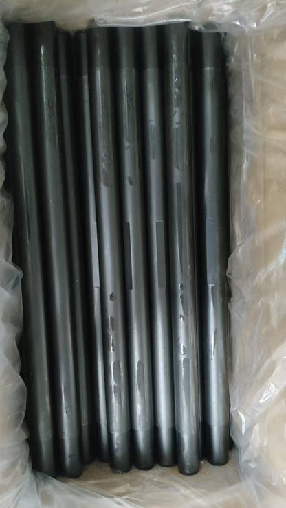 Black coated wireline flow tubes arranged in protective packaging.