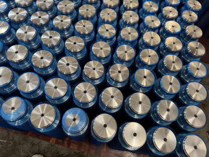 Blue-mesh-covered metal plunger bodies arranged together.