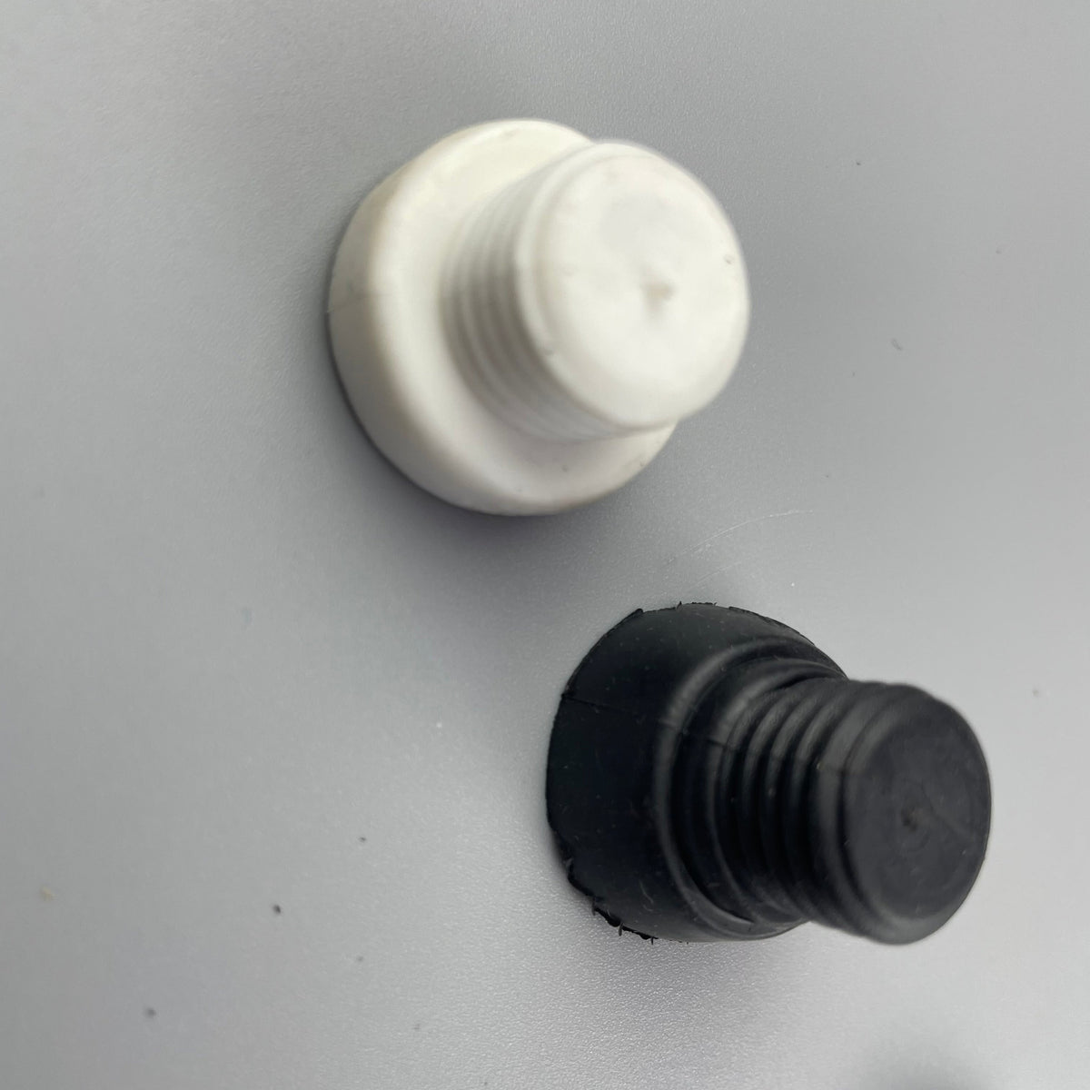 Molded rubber stoppers with stepped profiles