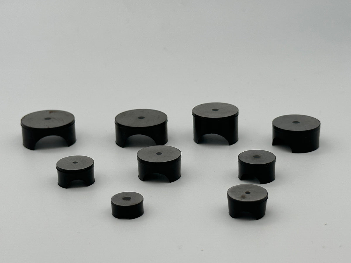 Molded rubber mounting rest pad with central hole and underside clearance arch