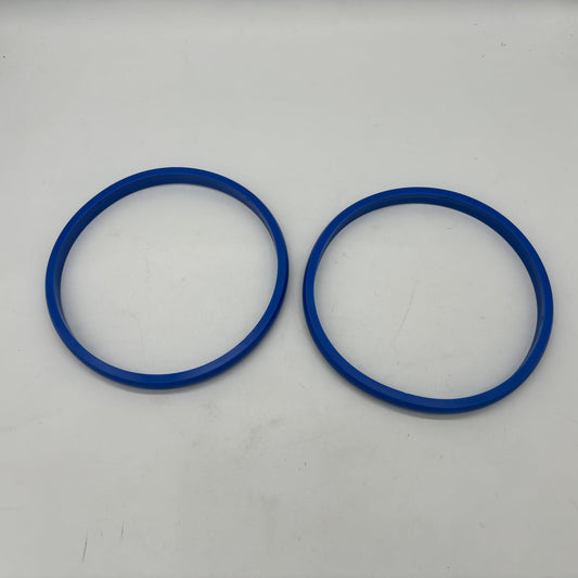 Two blue gauge port seal rings shown separately for profile comparison