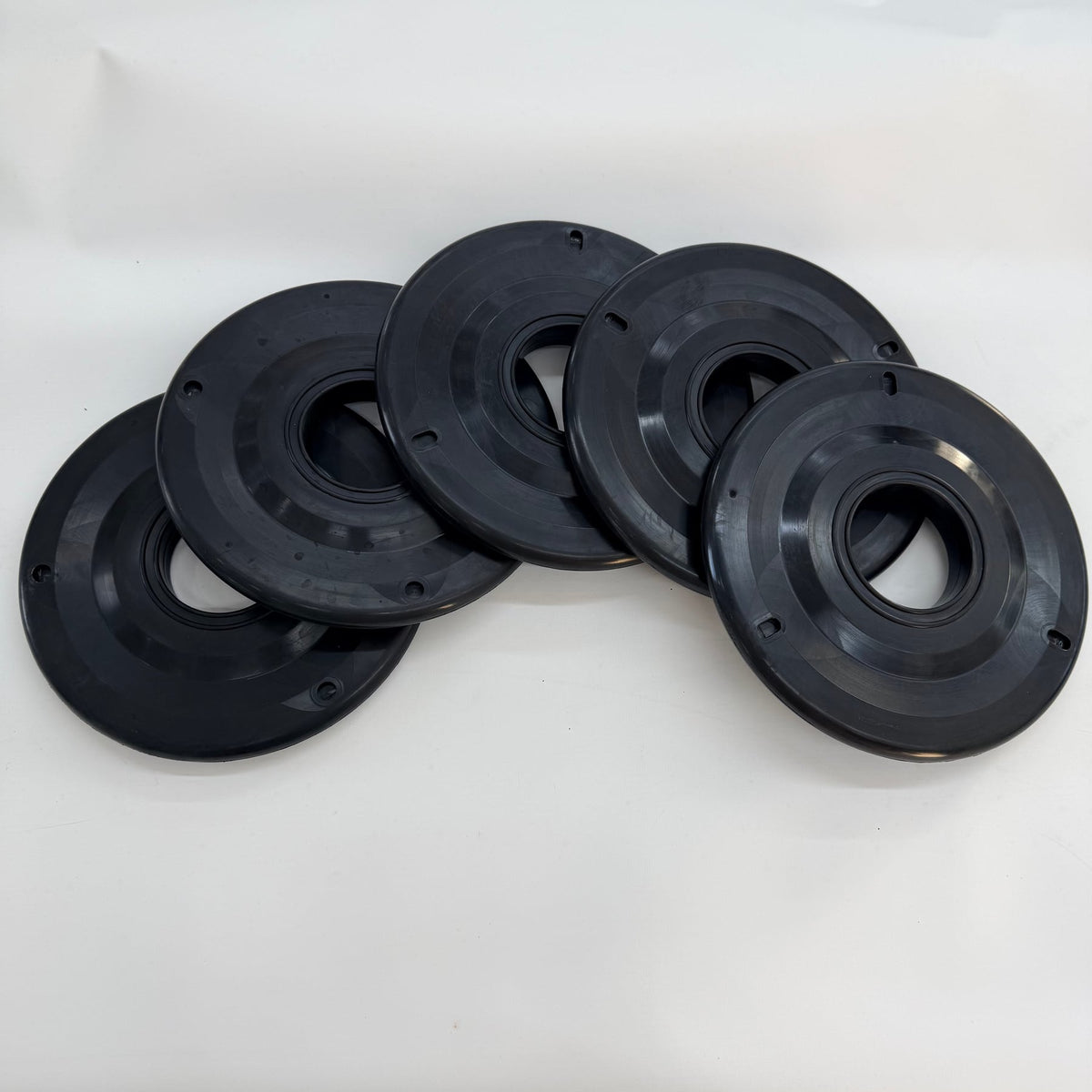 Group of circular black wiper elements arranged on a white background