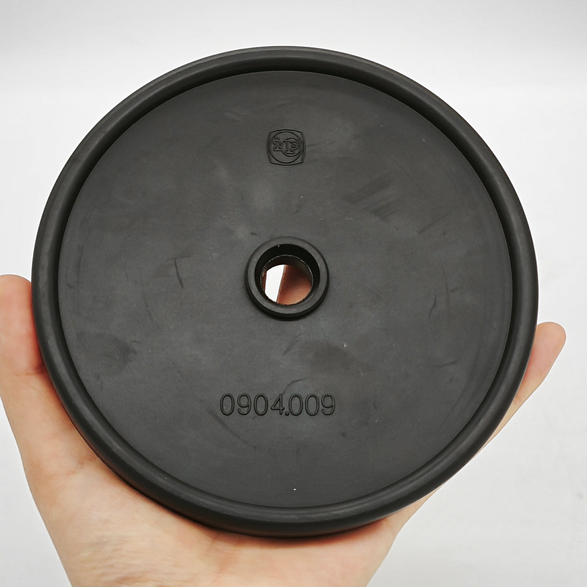 Black 0904.009 pump membrane with visible embossed model marking and center opening