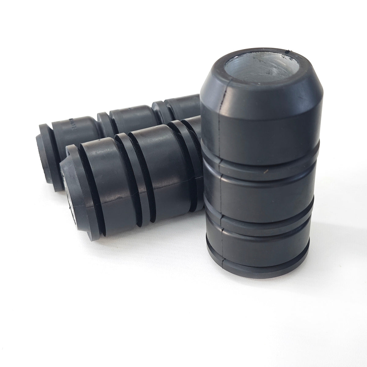 Group of black 3-1/2 inch TA-type tubing swab cups with metal cores