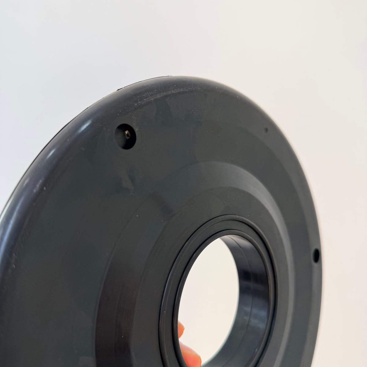 Close-up of the molded face, center opening and mounting holes on a 7 inch rubber pipe wiper