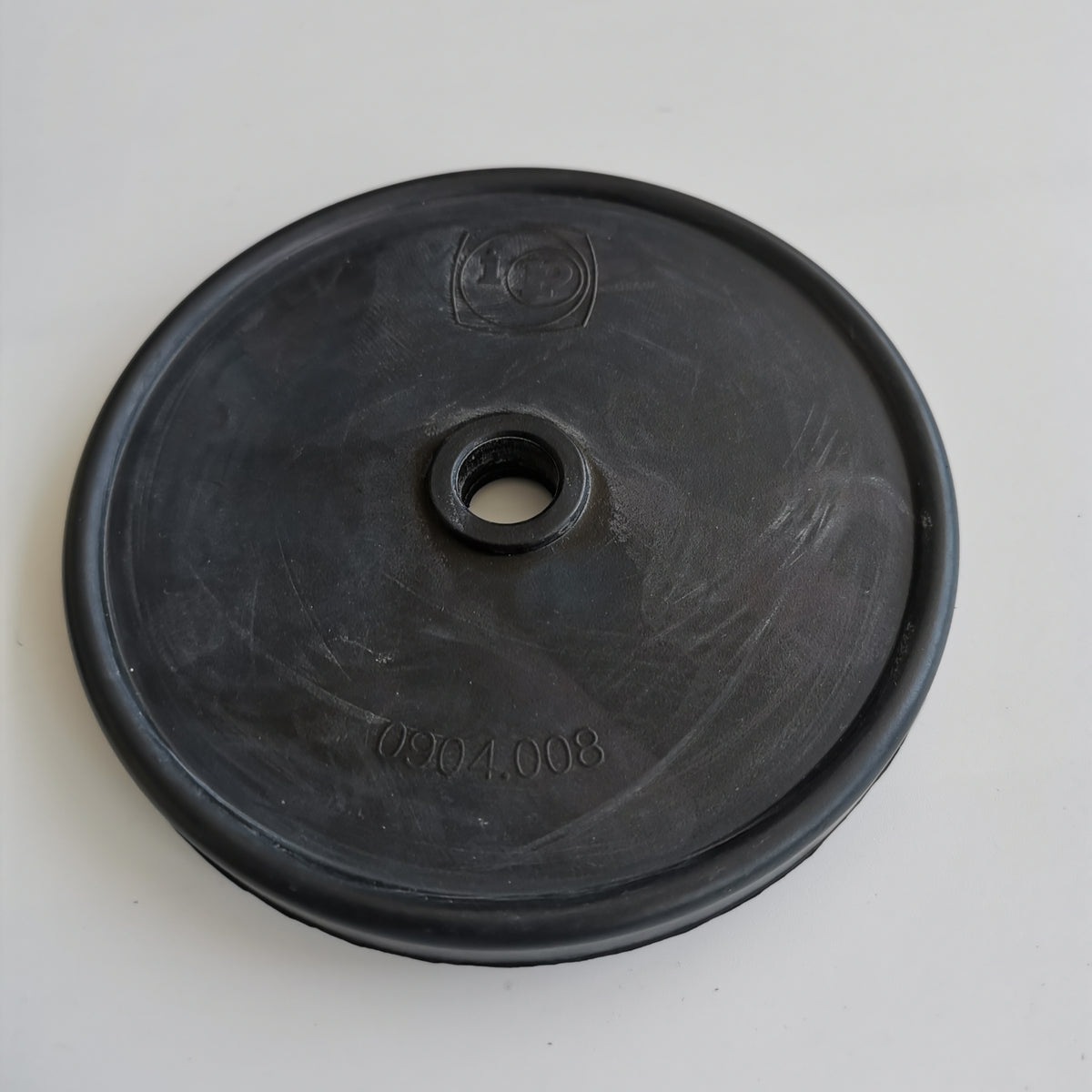 904008 pump membrane with molded model marking on a white background