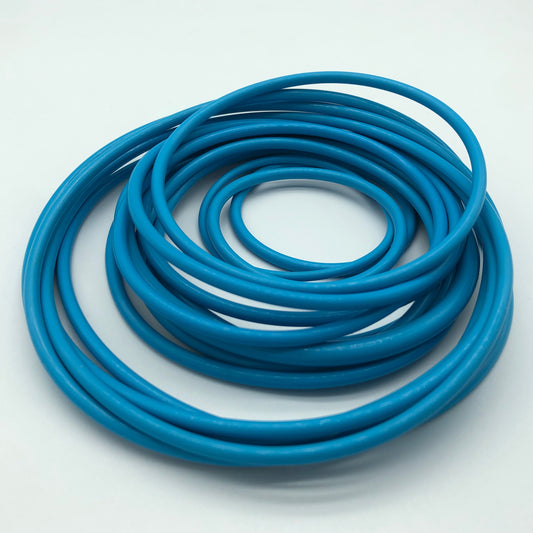 Coil of blue round rubber cord stock on a white background