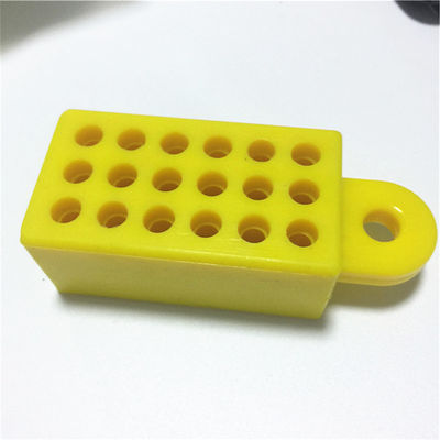 Yellow custom molded brake caliper bleeding spacer with perforated body and mounting tab