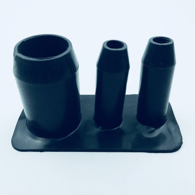 Custom molded rubber part with three upright cylindrical openings on a base image