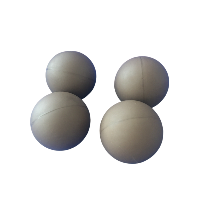 Four custom molded rubber balls with smooth spherical profiles