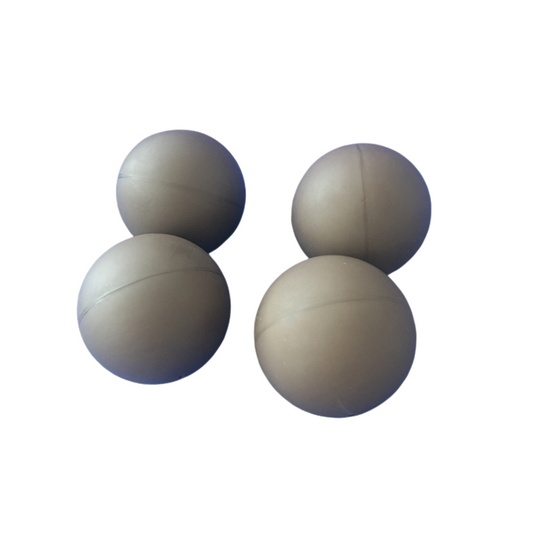Four custom molded rubber balls with smooth spherical profiles