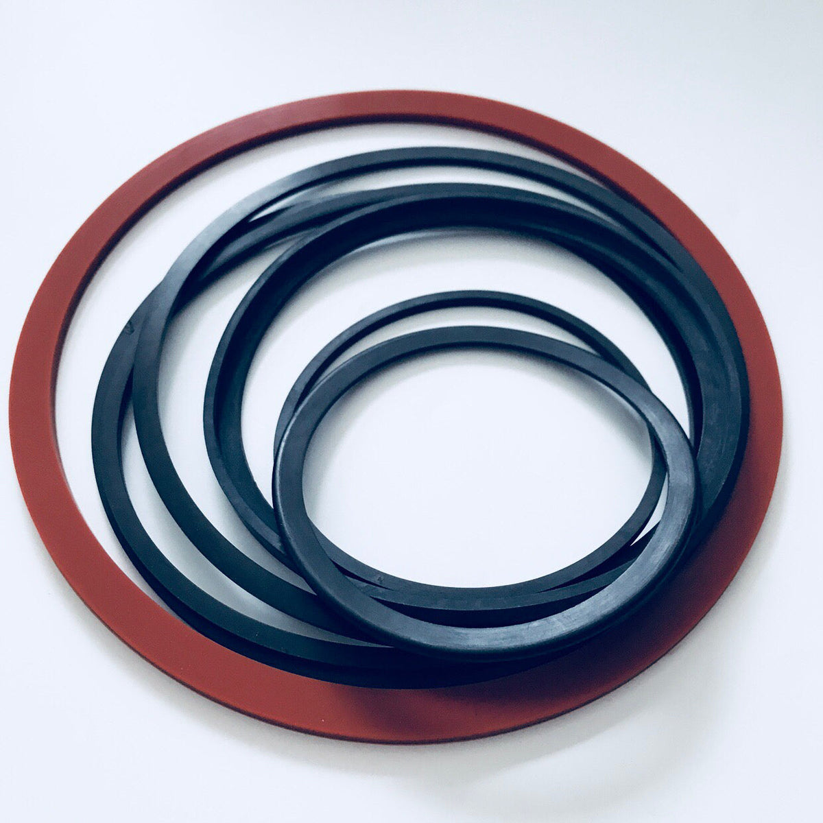 Assorted black and red custom molded rubber gasket rings with raised sealing profiles