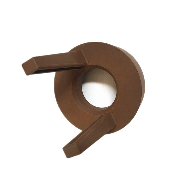 Custom molded rubber guide washer insert with central bore and two locating tabs