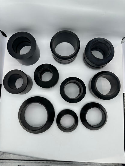Top detail of molded rubber sleeve profiles with varied bores and outer contours