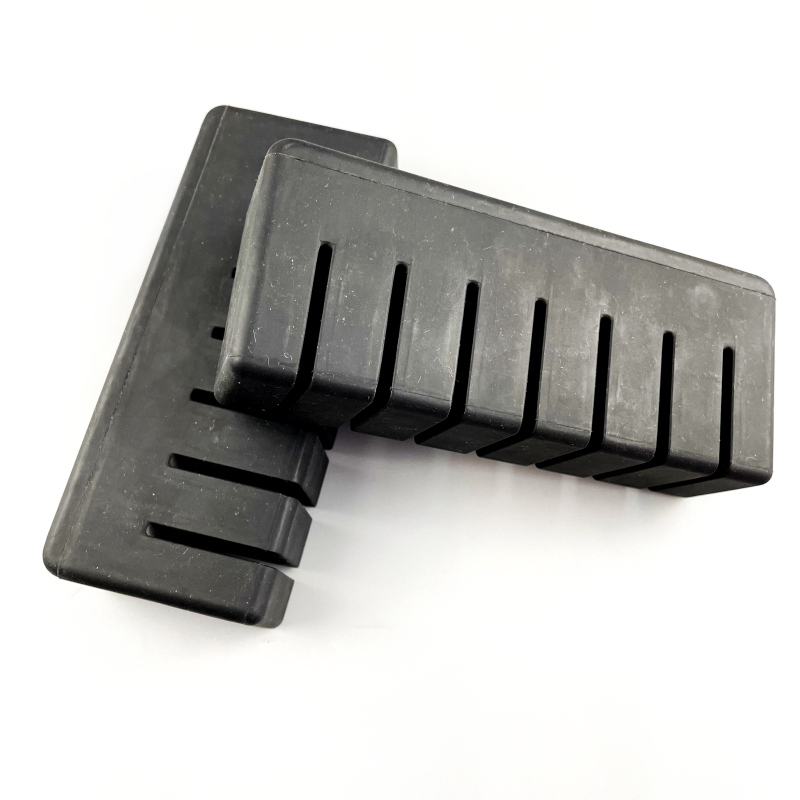 Rectangular molded rubber bumper blocks with transverse relief slots