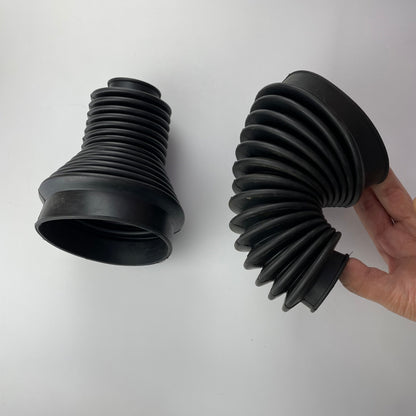 Two corrugated rubber bellows showing straight and flexed profiles
