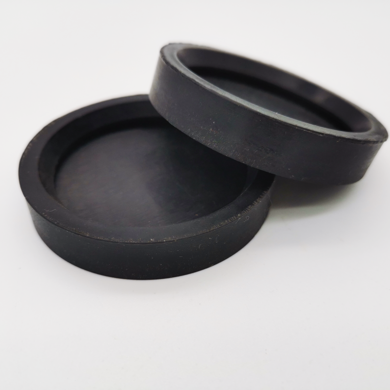 Two black shallow cup-shaped molded components with raised rims
