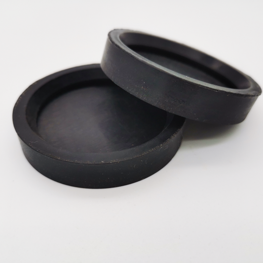 Two black shallow cup-shaped molded components with raised rims