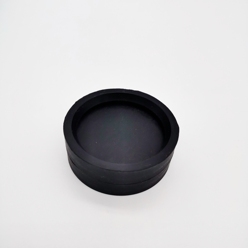 Top detail of a black shallow cup-shaped molded component