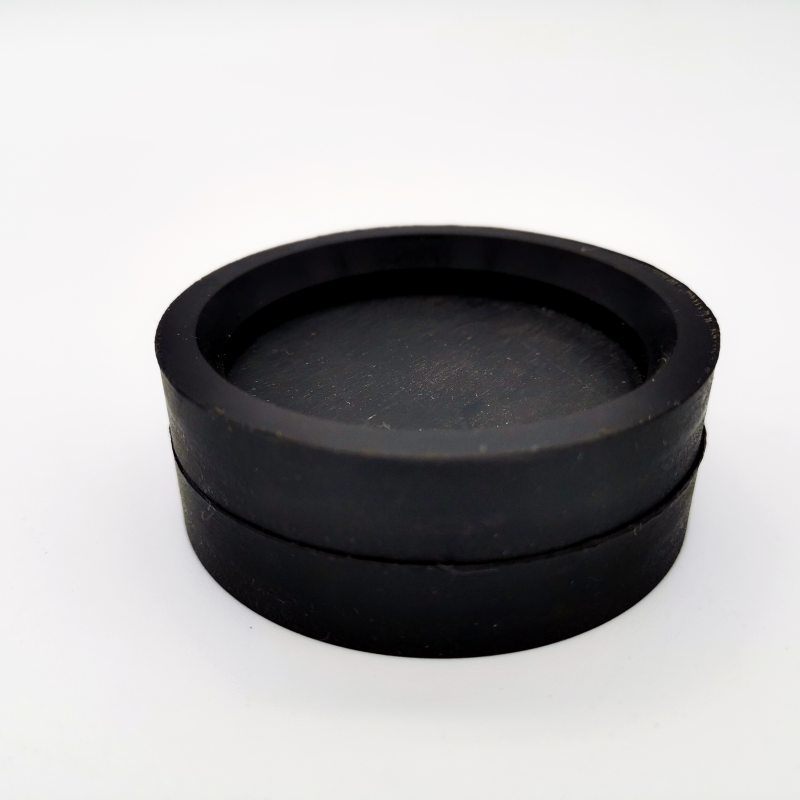 Black molded rubber protective cap with a recessed closed face and stepped outer wall