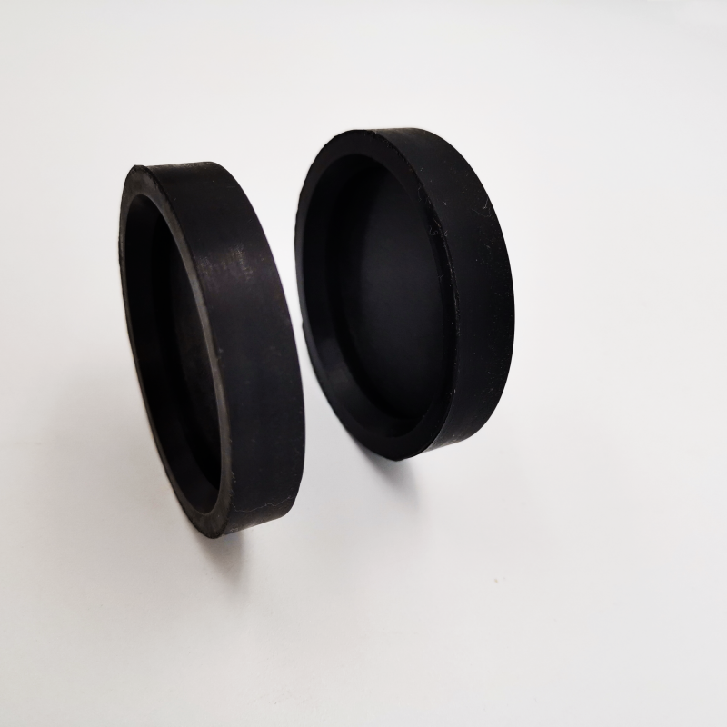 Pair of black molded rubber protective caps showing open and closed sides