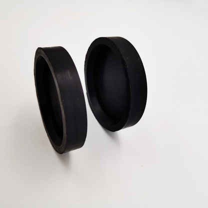 Pair of black molded rubber protective caps showing open and closed sides