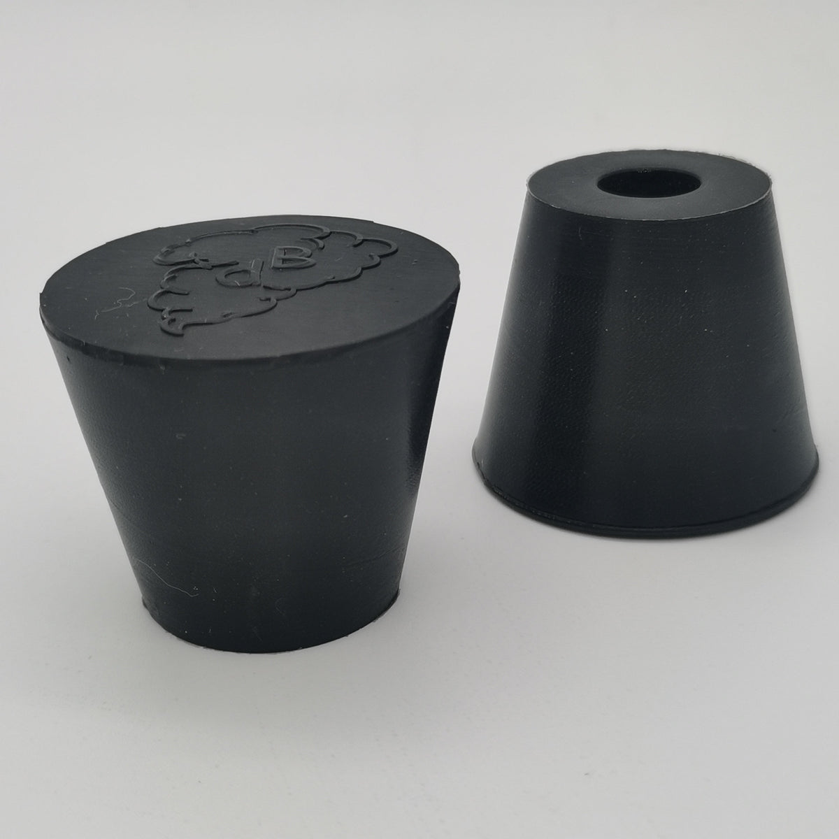 Molded rubber stopper with solid and one-hole configurations