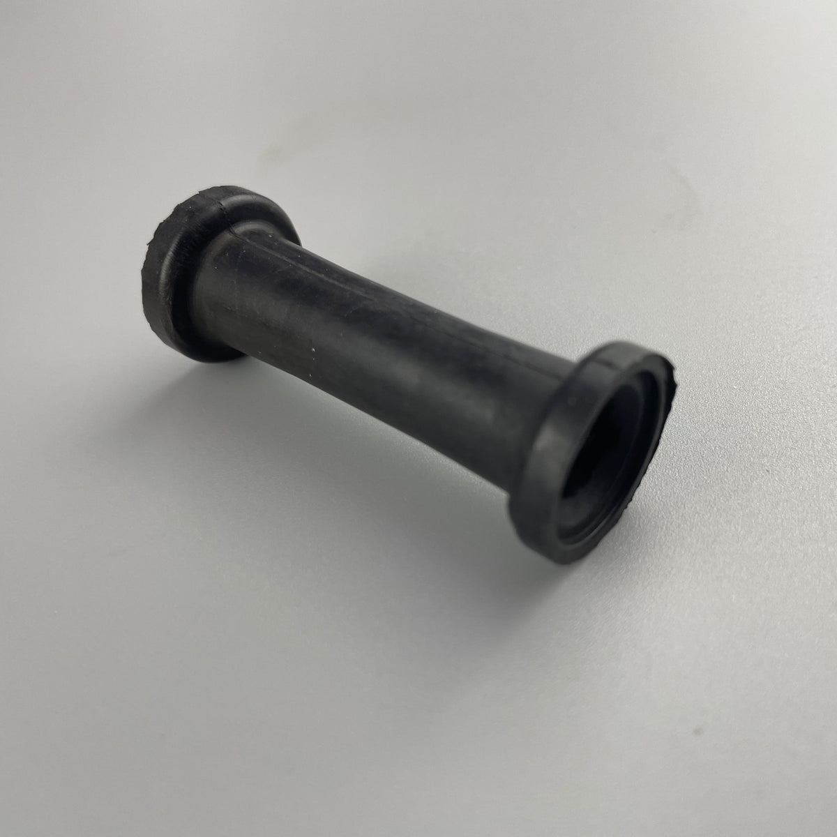 Double-flanged molded rubber sleeve bushing shown from the side