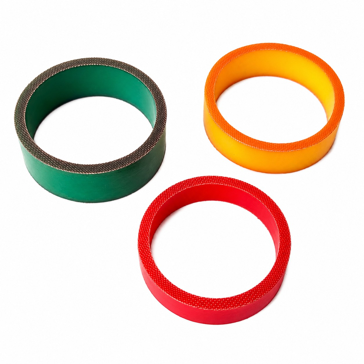 Fabric-reinforced hydraulic guide and wear ring examples