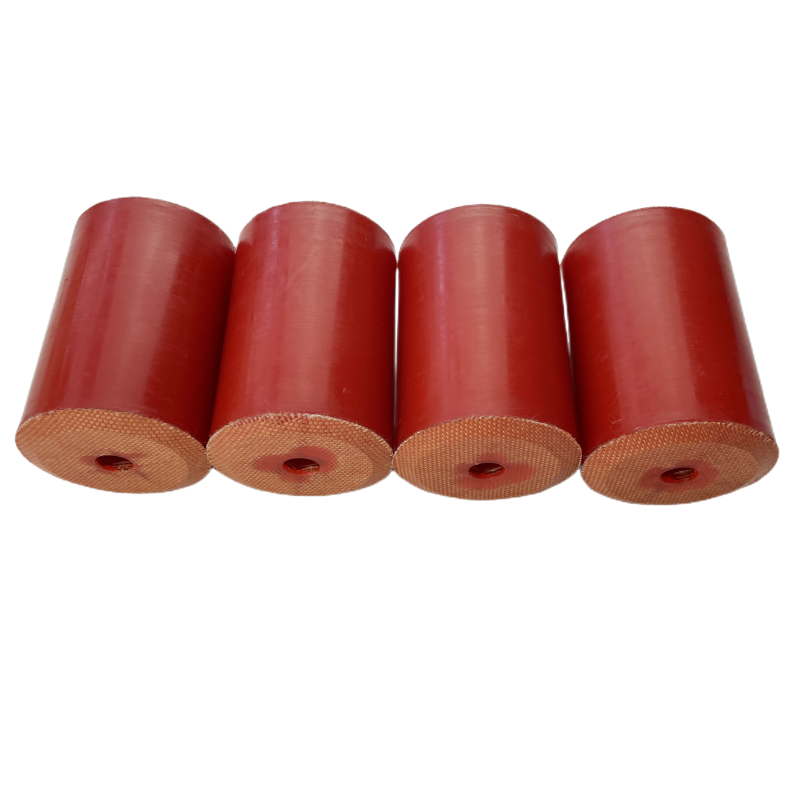 Red fabric-faced molded rubber cylinders showing side walls, center bores and reinforced end faces
