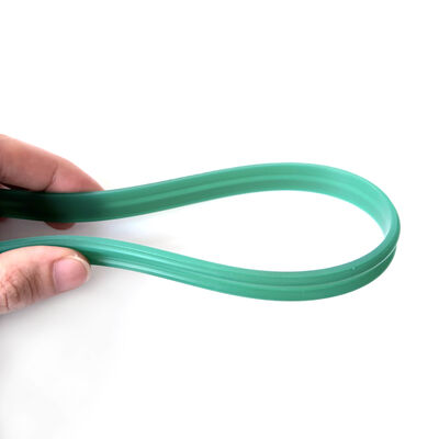 Green flexible circular seal ring shown bent to display its molded profile