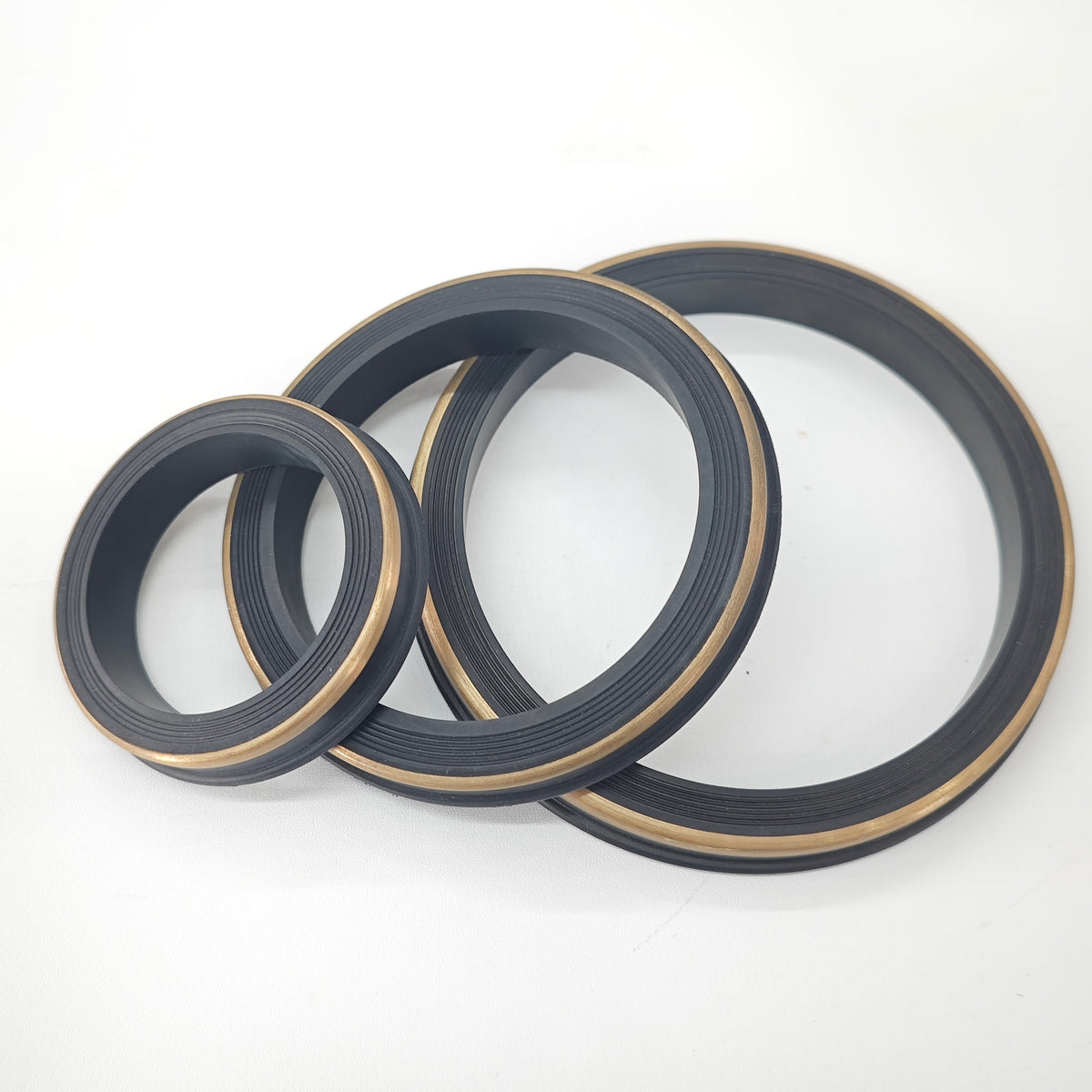 Representative hammer union seal rings with metallic backup bands