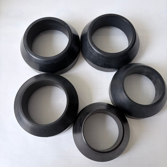 Five black annular components with tapered outer profiles
