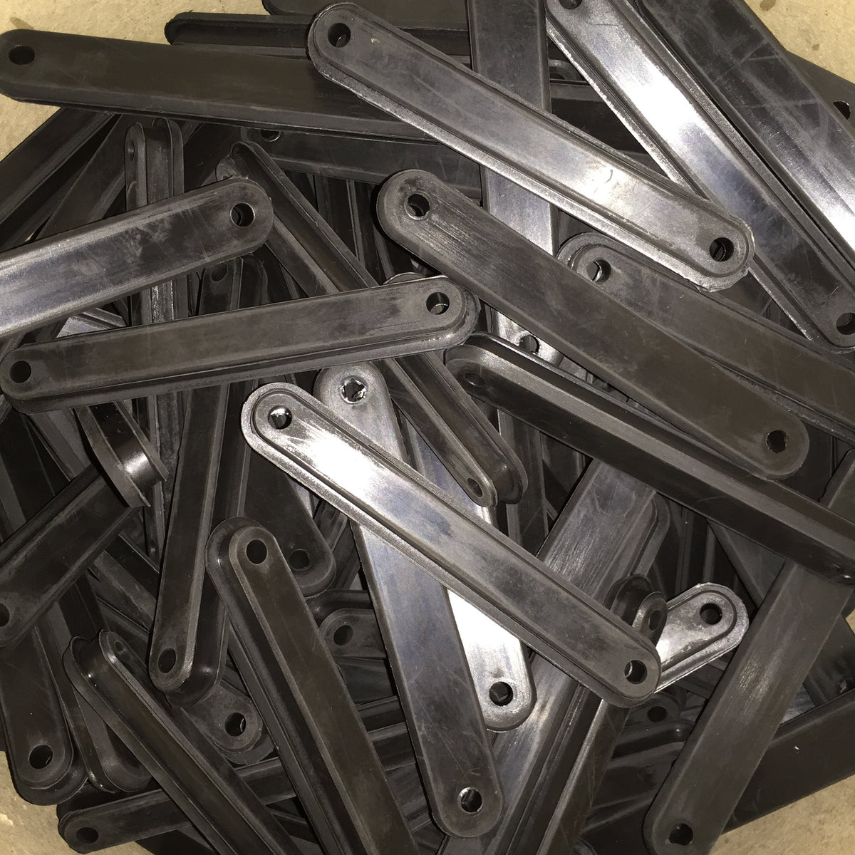 Long molded rubber strip bumpers with rounded ends and two mounting holes