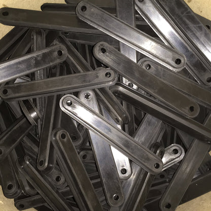 Long molded rubber strip bumpers with rounded ends and two mounting holes