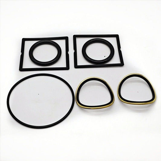 Plug valve seal components arranged on a white background
