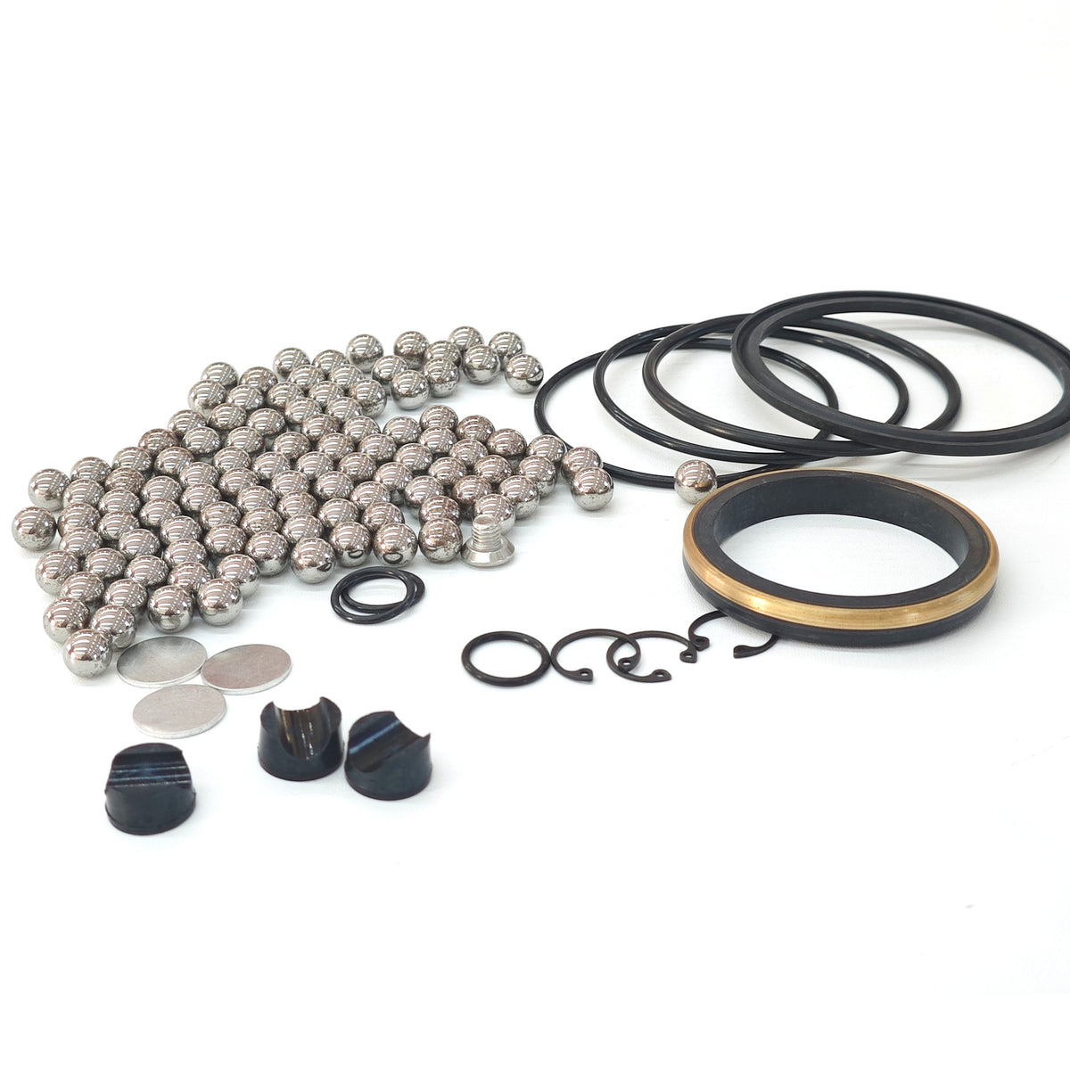 Elastomer repair-kit components with metal balls, sealing rings and gold-colored ring inserts.