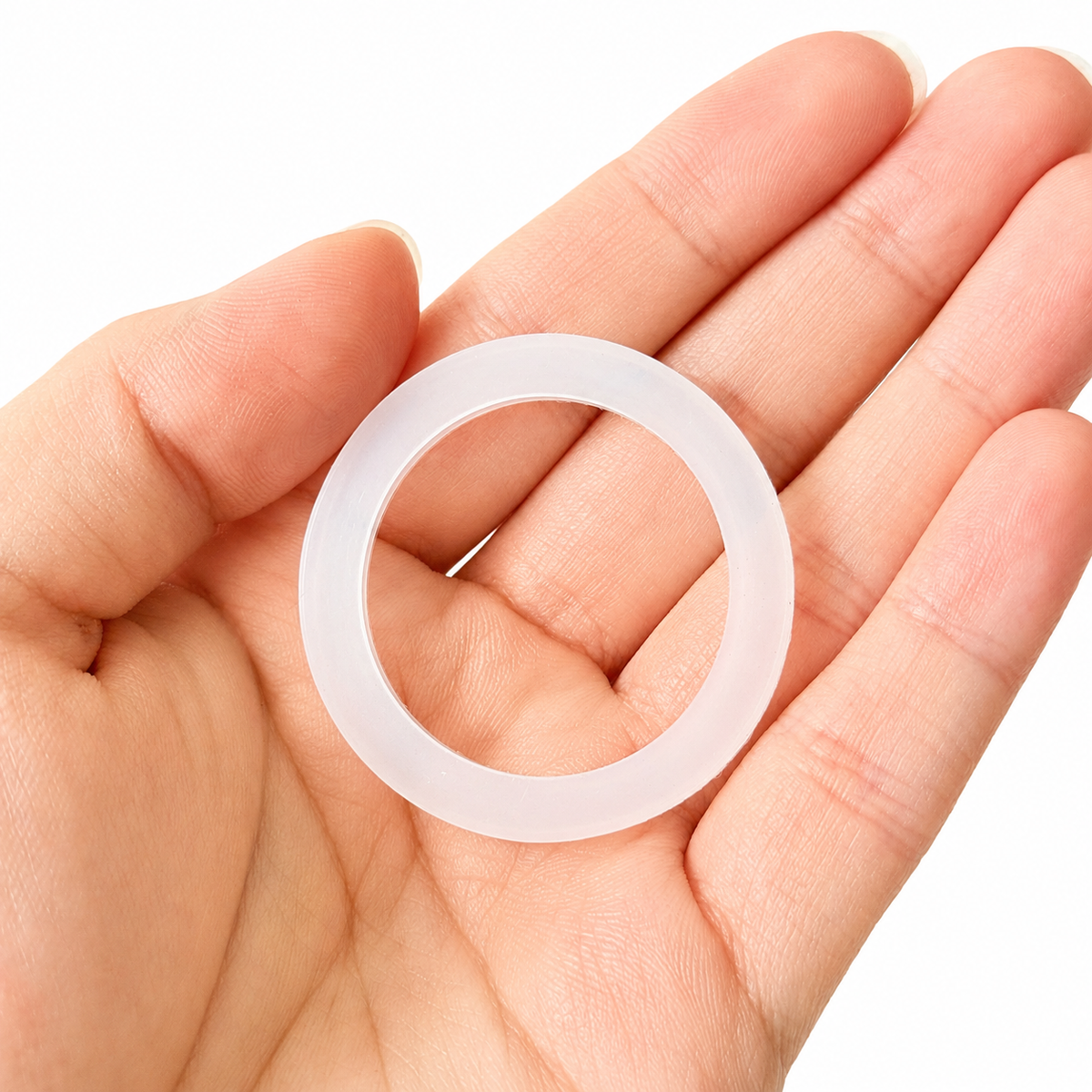 Translucent molded circular seal ring with a broad flat profile held in hand