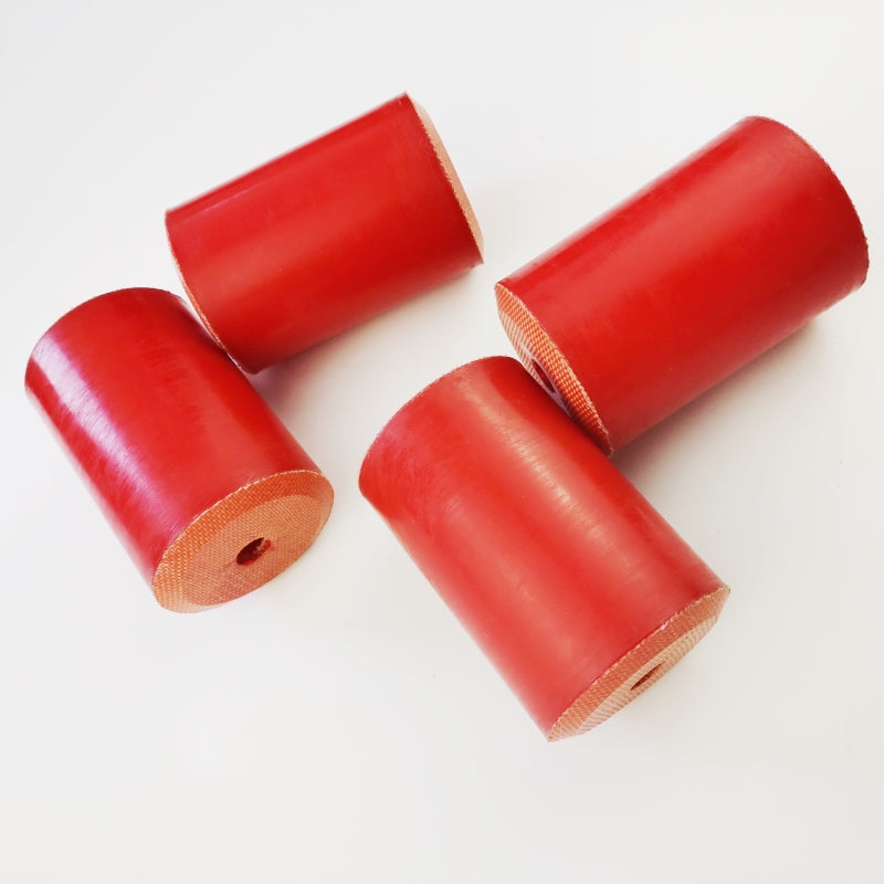 Red fabric-reinforced wireline oil saver rubber elements shown from the side