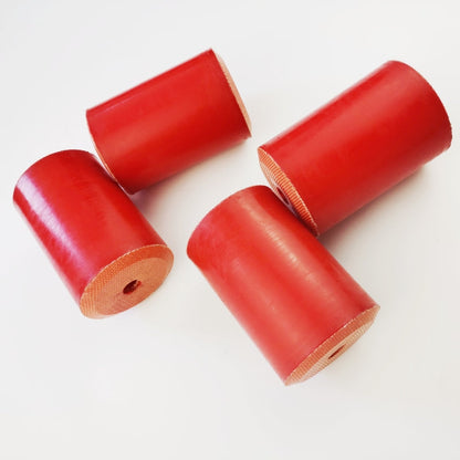 Red fabric-reinforced wireline oil saver rubber elements shown from the side